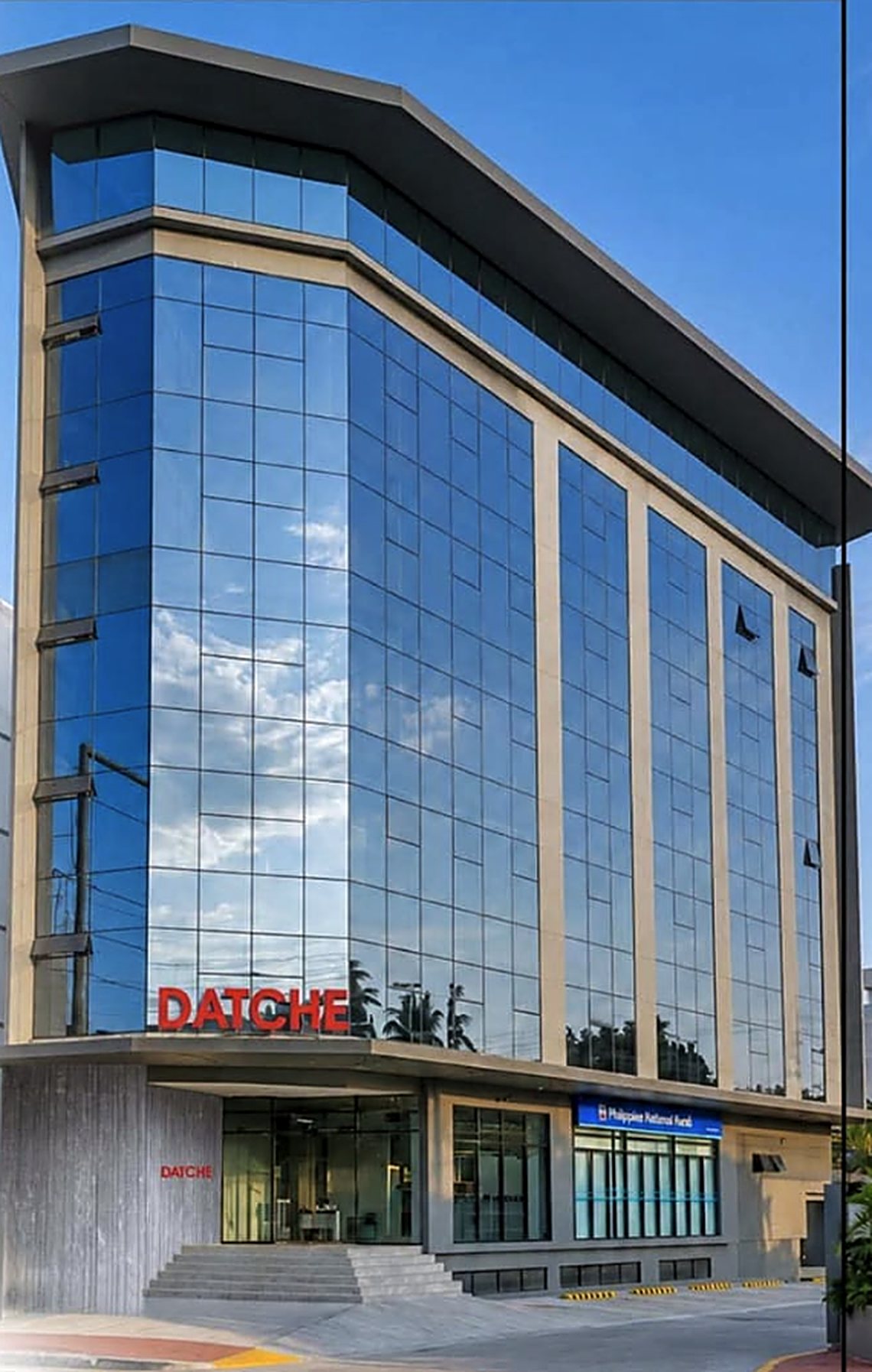The Datche building on M. Velez Street, Guadalupe, Cebu City — a glass-fronted
            office block with DATCHE in red above the entrance.